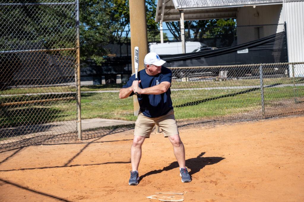 TRG team member up at bat Rinaldi Group team building
